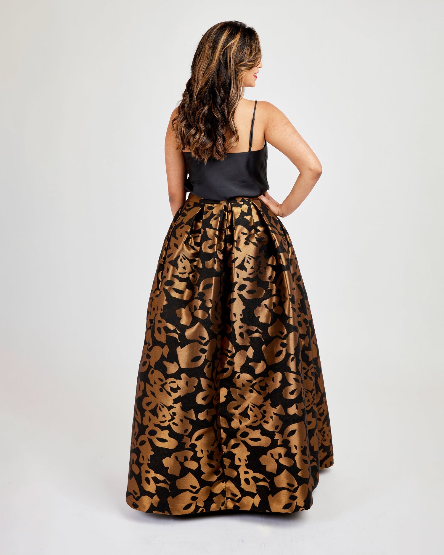 Woman wearing a black top and leopard print skirt on a white background. This skirt is the Upton Dress & Skirt sewing pattern from Cashmerette.