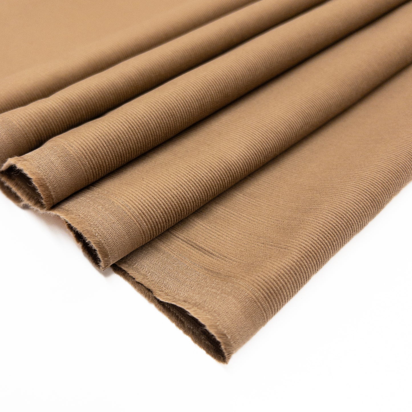 100% organic cotton baby corduroy shirting in a light brown shown folded