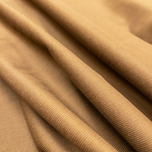 Face view of organic cotton garment fabric with slight folds illustrates small ribs of baby corduroy