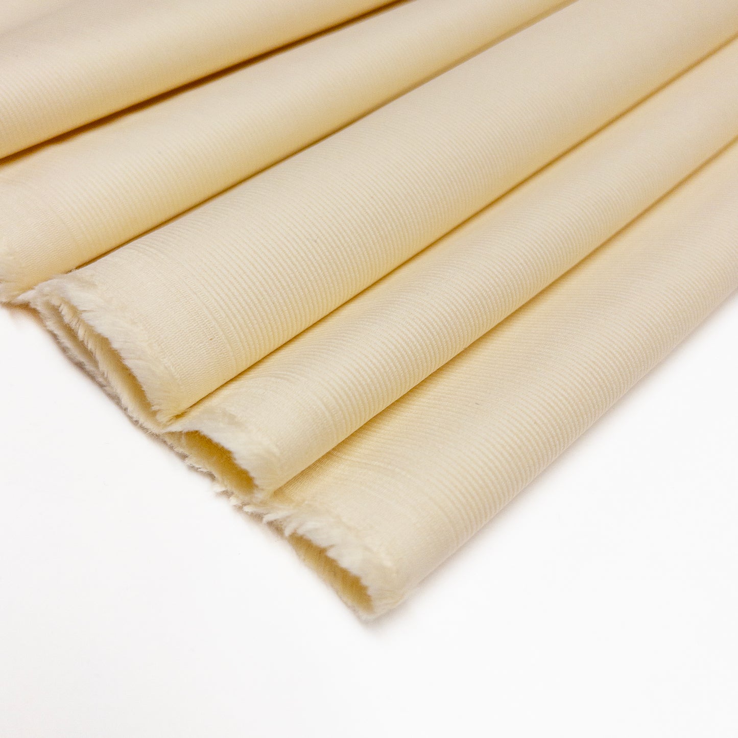 100% organic cotton garment fabric with fine corduroy ribs in white folded